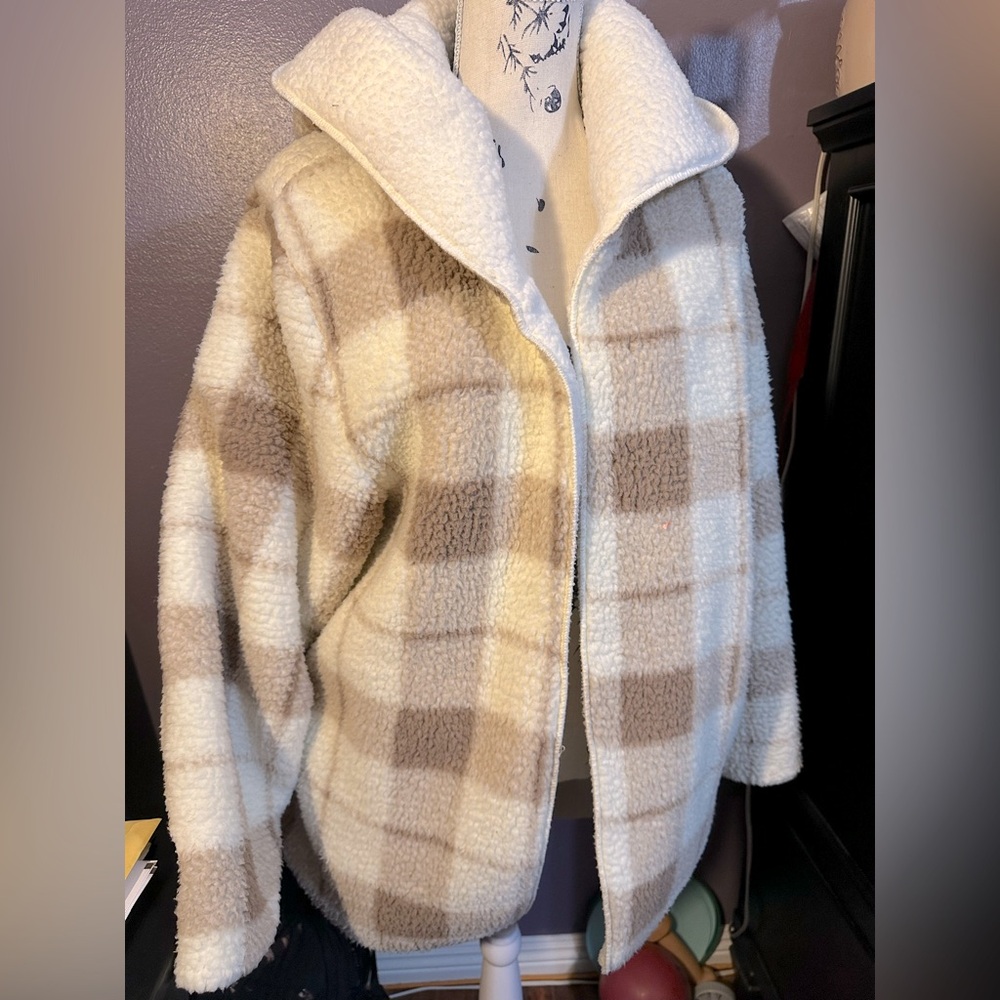 Plaid, polyester coat with a hood and pockets. Feel cozy like a blanket